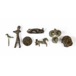 A group of Roman/Celtic antiquities including a lion bronze mount, an enameled shield brooch,