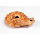 Roman Early Oil Lamp with Volute Nozzle, C. 1st Century AD.   An early Roman oil lamp in buff clay