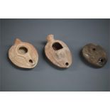 Byzantine Oil Lamp Group, 5th-6th century AD A group of three ceramic oil lamps with oval bodies,