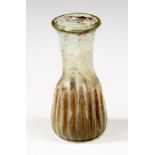 Roman glass ribbed bottle, C. 1st - 3rd Century AD.  A ribbed glass vessel with globular body. Size: