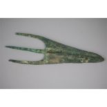 A bronze spear head with leaf shaped blade with pronounced central rib. Central tang with flanking