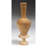 A long necked ceramic bottle attached to a pedestal base, most likely from the Cyprus region.