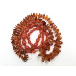 A string graduated naturally shaped amber beads, length approx 79cms,