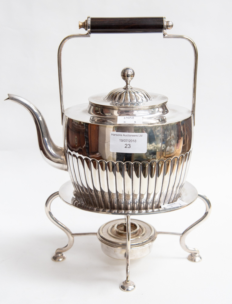 A silver plated teapot with stand