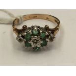 A 9ct gold ladies dress ring set with illusion set round diamonds and emeralds, ring size U,