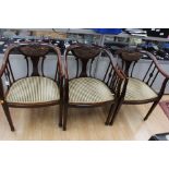 A set of three Edwardian mahogany tub chairs