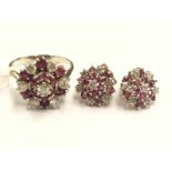 A diamond and ruby cluster ring, with seven brilliant cut diamonds, interspersed with rubies,