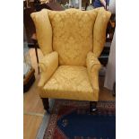 A 19th Century wing back armchair with recent yellow damask upholstery,