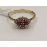 An 18ct gold ruby and diamond lozenge shape cluster ring, approx total assessed ruby weight 0.