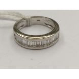 An 18ct white gold diamond ring, the diamonds being bagette cut and channel set, ring size J,