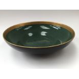 A Royal Worcester bowl; ogee shaped with shell ans scroll guilt rim against a sage green ground.