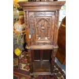 A solid oak carved side cabinet in the manner of Pugin,
