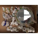 Floral encrusted ceramic mirror with cherubs, with assorted Continental figures,