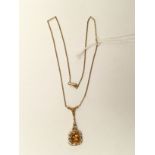 An 18k marked continental pendant, set to the centre with a buff top citrine,