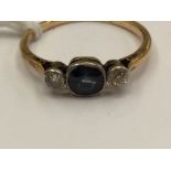 A sapphire and diamond three stone ring