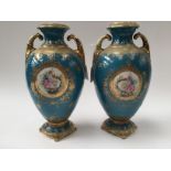 A pair of Japanese twin handled vases,