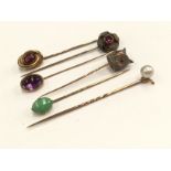 A stick pin, the finial cast as Owl's head and five others, set cultured pearl, jade, garnet,