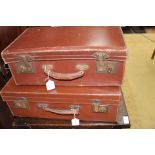 Two early to mid 20th Century brown leather suitcases,