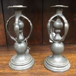 A pair of Arts and Crafts pewter candle holders,