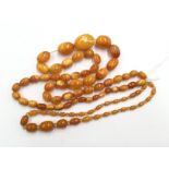 Two amber coloured/type necklaces,