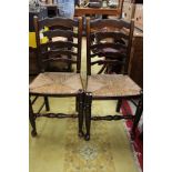 A set of four 20th Century rush seated ladder back chairs (4)