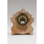 A French ceramic 8-day mantle clock, hand painted floral decoration, enamelled dial, Roman numerals,