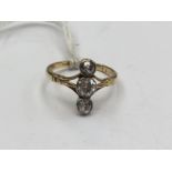 An Edwardian diamond ring, with three diamonds set to the length of the finger, 'the past,