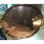 A circular copper table top, no base,
