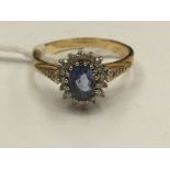 A sapphire and diamond 18ct gold ring, oval sapphire approx 0.99ct, total diamond weight approx 0.