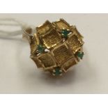 A 14k gold ring, set in contemporary setting, with green stone (possibly emeralds) chips, approx 5.