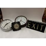 Two Bakelite clocks and two circa 1950s EXIT light signs,