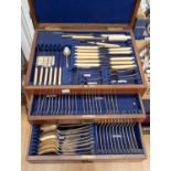 An oak canteen of cutlery, two drawers with hinged cover, including sauce ladles, knife rests, etc,