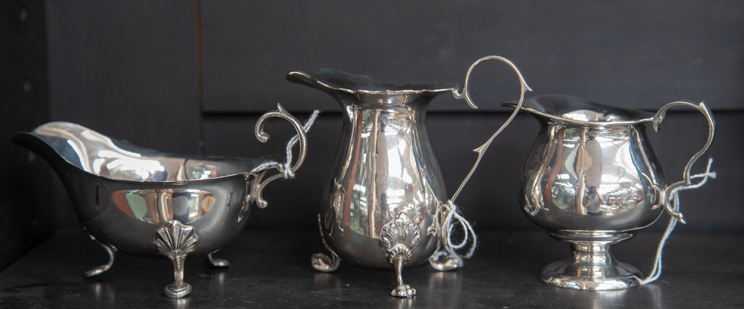 A collection three various silver cream jugs,