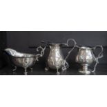 A collection three various silver cream jugs,