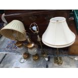 A pair of brass Corinthian Column lamps together with a pair of glass lamps with gilded base and