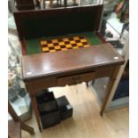 An Edwardian fold-over mahogany card table, standing on square tapered legs, 76cm high, 90cm wide,