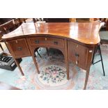 A George III mahogany sideboard, in the Sheraton style, of concave form,