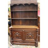 A carved oak dresser and rack, the rack having two shelves,