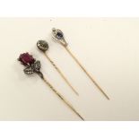 Three various Edwardian stick pins, set garnet and old cut diamonds,