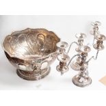 A silver on copper punch bowl with repouse detail, lion head ring handles,