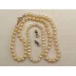 A cultured pearl necklace with 9ct clasp and a cultured pearl bracelet and pair of stud earrings