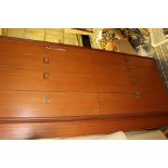 A late 20th Century teak sideboard, fitted with eight drawers,