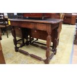 An early 20th Century oak side table, fitted with a single drawer,