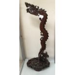 A Chinese carved wooden stand, 20th Century, in the form a dragon, possibly for a dinner gong,