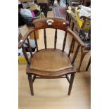 A late 19th Century beech captains chair, pierced back rest, later seat,