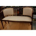 An Edwardian inlaid and strung double settee,