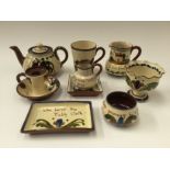 A collection of various Torquay pottery in terracotta, with cream glaze, including teapot,