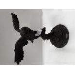 A modern cast bronze figure of an owl with outstretched wings, mounted on a marble base,