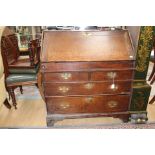 A George I oak bureau, circa 1720, the fall enclosing a fitted interior,