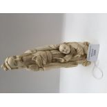 A Japanese ivory tusk carving, Meiji period, 1868-1912, as a robed bearded elder holding a chick,